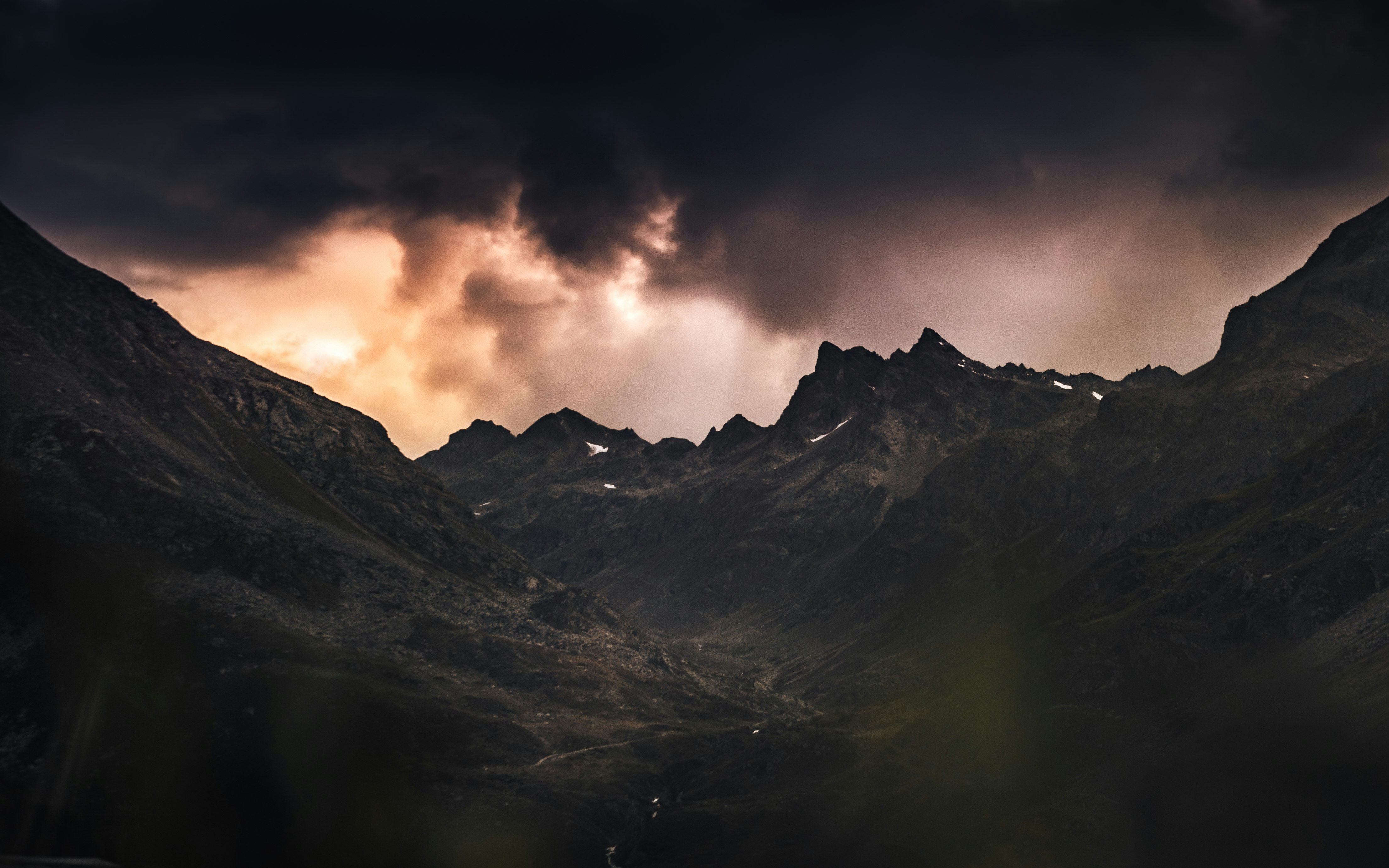 black and white mountains under cloudy sky